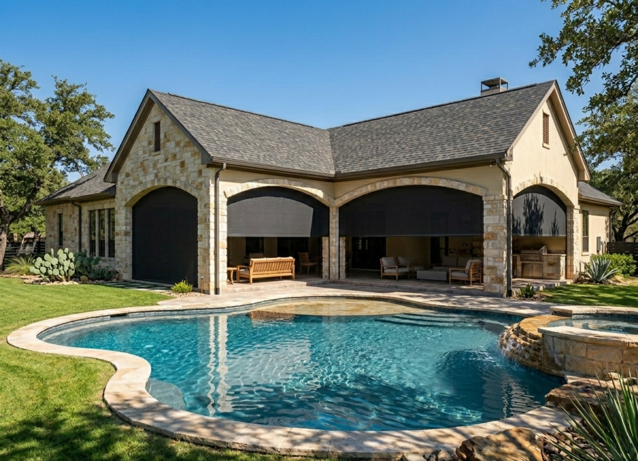 Stone house with backyard pool and patio furniture.